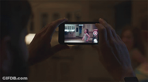 A Person Is Taking A Picture Of A Little Girl On A Phone GIF