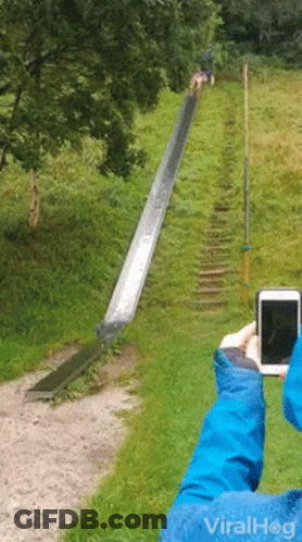 A Person Is Taking A Picture Of A Slide With A Cell Phone With Viralhog Written On It GIF