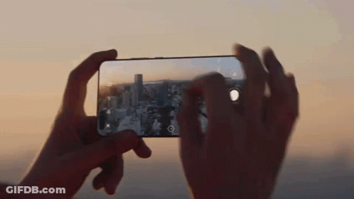A Person Is Taking A Picture With A Cell Phone GIF