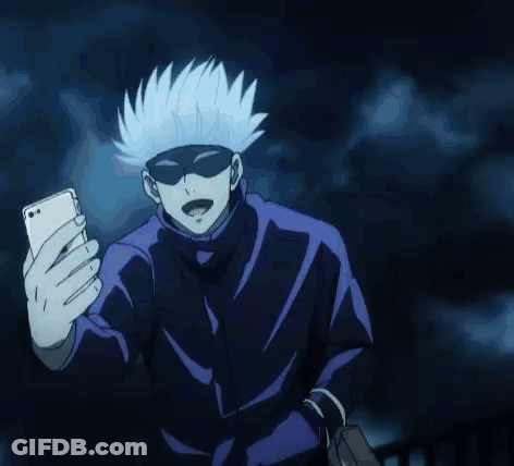 A Person Is Taking A Selfie With A Cell Phone In The Dark . GIF