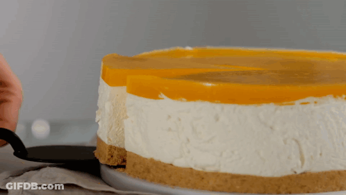 A Person Is Taking A Slice Of Cheesecake GIF