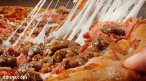 A Person Is Taking A Slice Of Pizza With Meat And Cheese . GIF