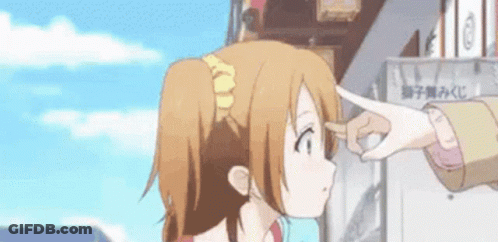 A Person Is Touching A Girl 'S Forehead With Their Finger While Standing In Front Of A Building . GIF