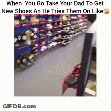 A Person Is Trying On A Pair Of Shoes In A Store . GIF