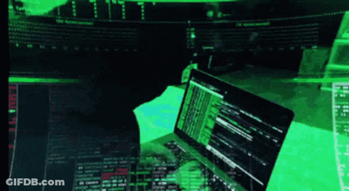 A Person Is Typing On A Laptop With A Green Screen Behind Them GIF