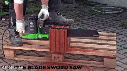 A Person Is Using A Double Blade Sword Saw To Cut A Piece Of Wood GIF