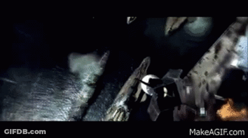 A Person Is Walking Down A Hallway With Pipes Hanging From The Ceiling GIF