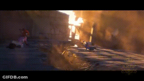 A Person Is Walking Down A Street In Front Of A Building . GIF
