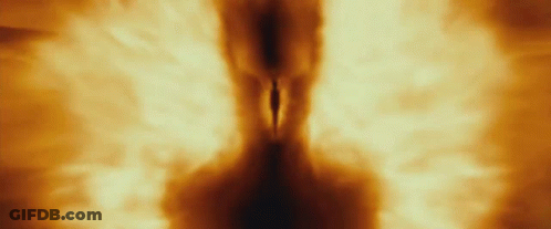 A Person Is Walking Through A Tunnel Of Fire And Smoke GIF