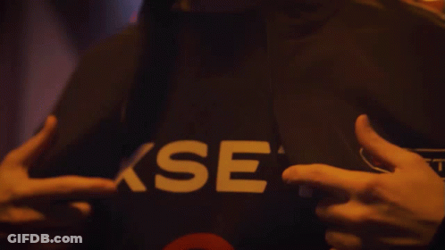 A Person Is Wearing A Black Shirt With The Word Xset On It GIF