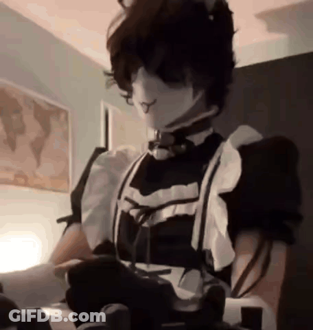 A Person Is Wearing A Maid Costume And Holding A Video Game Controller . GIF