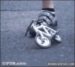 A Person Is Wearing A Pair Of Shoes That Look Like A Small Bicycle . GIF