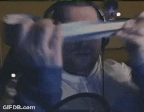 A Person Is Wearing A Virtual Reality Headset And Headphones While Sitting In Front Of A Computer Screen . GIF