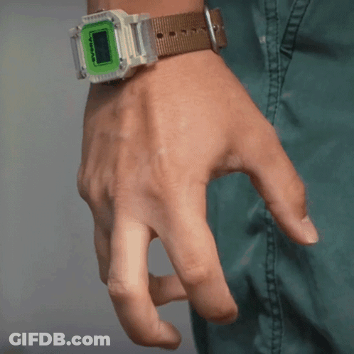 A Person Is Wearing A Watch With A Green Face And A Brown Band GIF