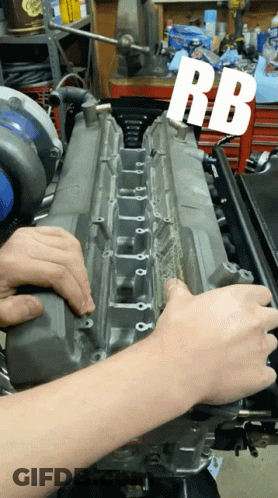 A Person Is Working On A Car Engine With The Letters Rb Visible GIF