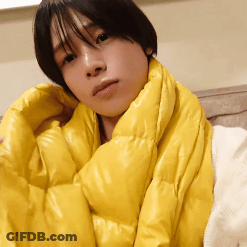 A Person Is Wrapped In A Yellow Scarf GIF