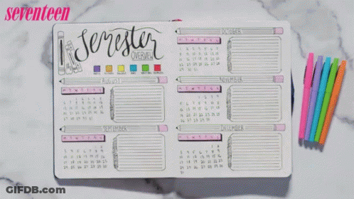 A Person Is Writing In A Notebook With Seventeen Written On The Top GIF
