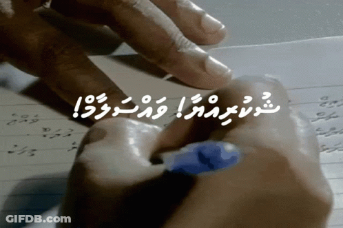 A Person Is Writing On A Piece Of Paper With A Blue Marker GIF