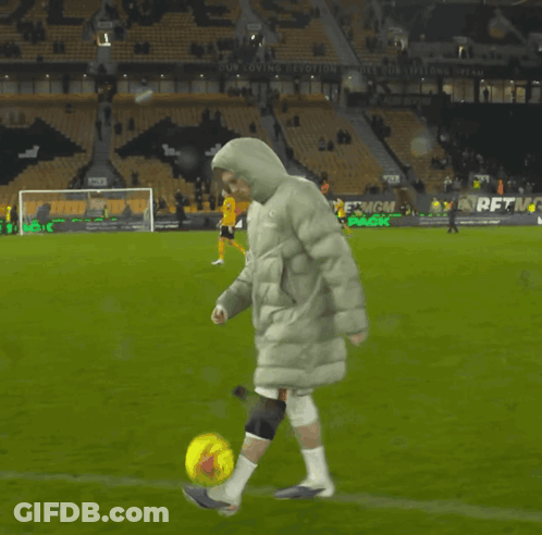 A Person Kicking A Soccer Ball On A Field That Has A Sign That Says " Our Loving Evolution " GIF