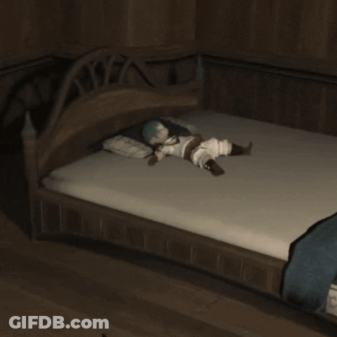 A Person Kneeling In Front Of A Bed With A Blue Blanket On It GIF
