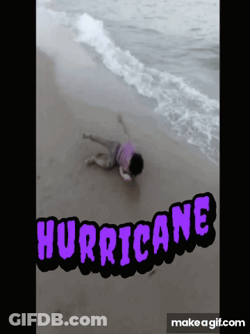 A Person Laying On A Beach With The Word Hurricane Written On It GIF