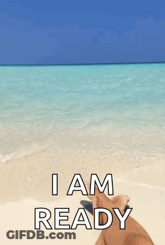 A Person Laying On A Beach With The Words " I Am Ready " GIF