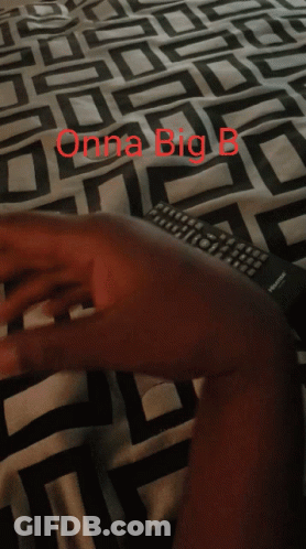 A Person Laying On A Bed With A Blanket That Says Onna Big B On It GIF