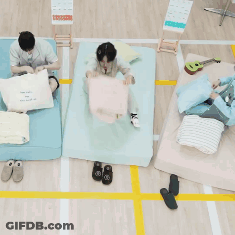 A Person Laying On A Bed With A Pillow That Says ' I Love You ' GIF