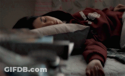 A Person Laying On A Bed With A Sweatshirt On That Says Harvard GIF
