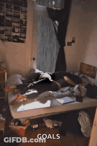 A Person Laying On A Bed With The Word Goals Written On The Bottom GIF