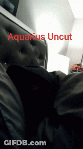 A Person Laying On A Bed With The Words Aquarius Uncut On The Bottom Right GIF