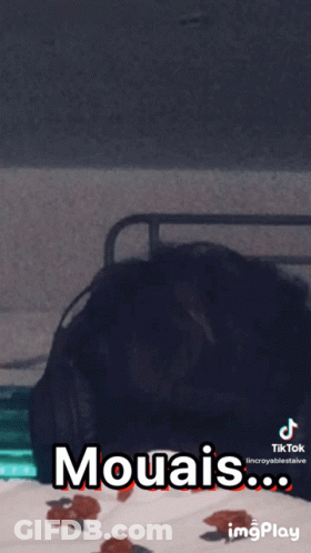 A Person Laying On A Bed With The Words Mouais Written On The Screen GIF