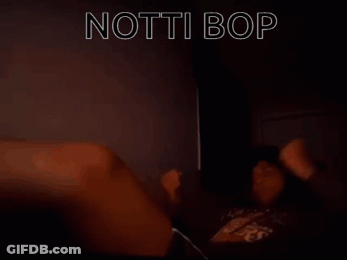 A Person Laying On A Bed With The Words " Notti Bop " In White Letters GIF
