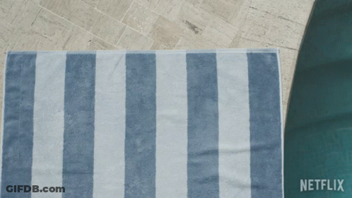 A Person Laying On A Blue And White Striped Towel With Netflix Written On The Bottom GIF