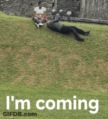A Person Laying On The Grass With The Words I 'M Coming Written Below Them GIF