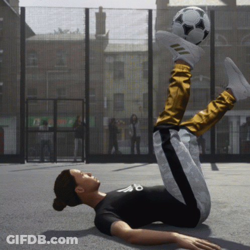 A Person Laying On The Ground With A Soccer Ball On Their Foot GIF