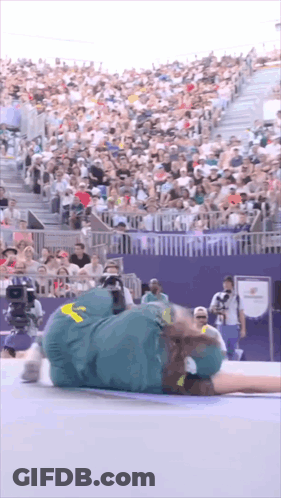 A Person Laying On The Ground With A Yellow Sticker On Their Pants GIF