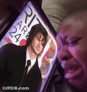 A Person Looking At A Picture Of A Man With The Number 24 On The Screen GIF