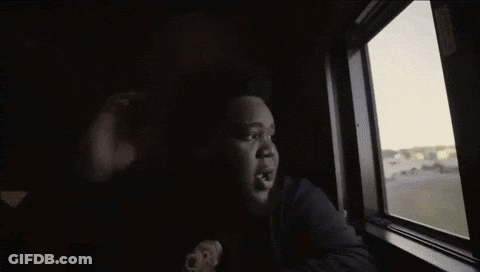 A Person Looking Out Of A Window With A Hole In It GIF