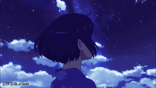 A Person Looking Up At A Blue Sky With Clouds And Stars GIF