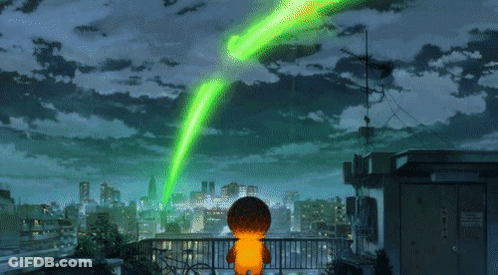 A Person On A Balcony With A Green Light Coming From The Sky GIF