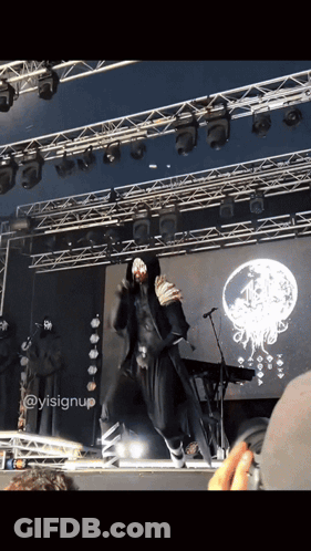 A Person On A Stage With A Sign That Says ' Ysisignup ' GIF