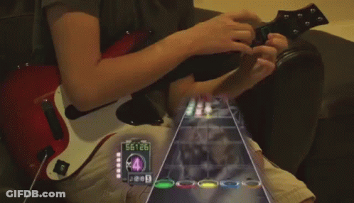 A Person Playing A Guitar With A Screen Showing The Number 88926 GIF