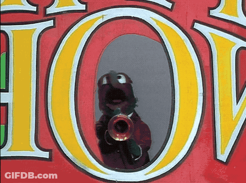 A Person Playing A Trumpet In Front Of A Sign That Says " Hot " GIF