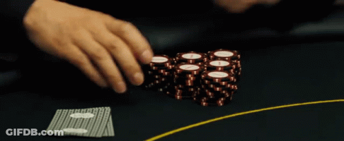 A Person Playing Poker With A Stack Of Chips That Have The Letter I On Them GIF