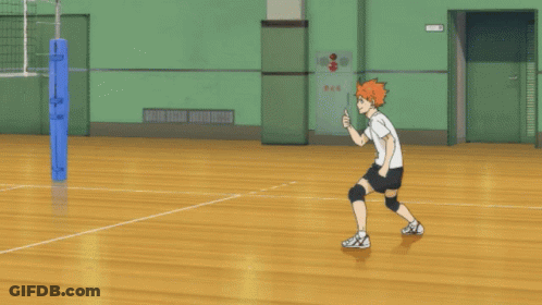 A Person Playing Volleyball In A Gym With A Sign On The Wall That Says Fire GIF