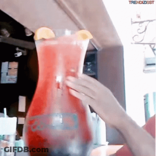 A Person Pouring A Drink Into A Pitcher That Says Trendzisst On The Bottom GIF
