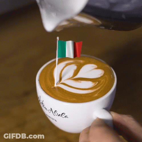 A Person Pouring Milk Into A Cup Of Coffee That Says Aitan Aliola On It GIF