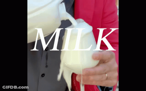 A Person Pouring Milk Into A Glass With The Word Milk Written On It GIF