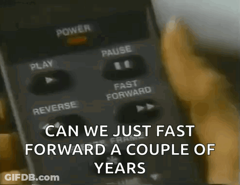 A Person Pressing A Button On A Remote Control With The Words Can We Just Fast Forward A Couple Of Years GIF